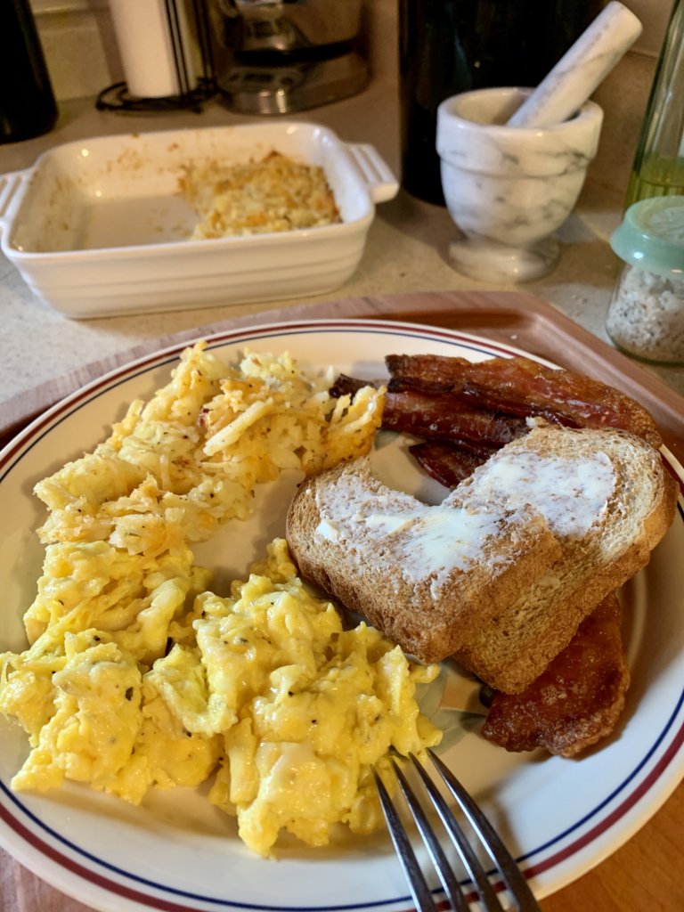 Scrambled Eggs With Butter Cheese, Hash Brown Casserole, Bacon, And Toast