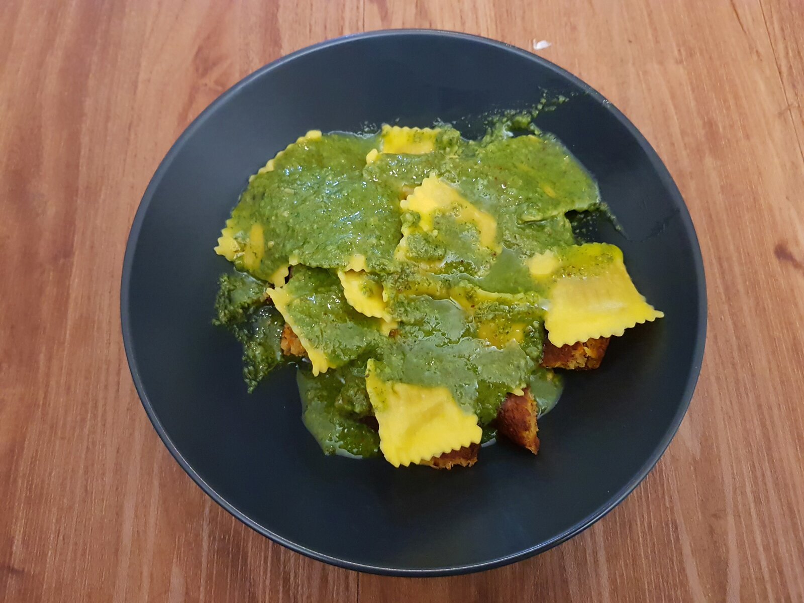 Shop bought vegan ravioli with homemade sorrel & almond pesto and a veggie burger underneath