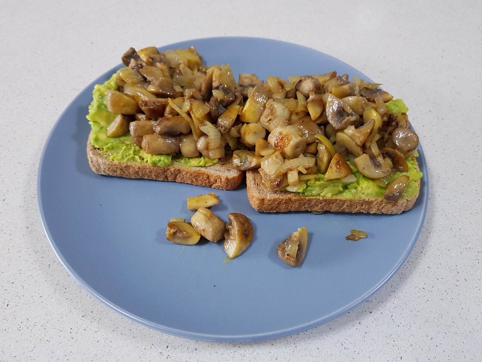Smashed Avo, fried mushrooms and onions on toast