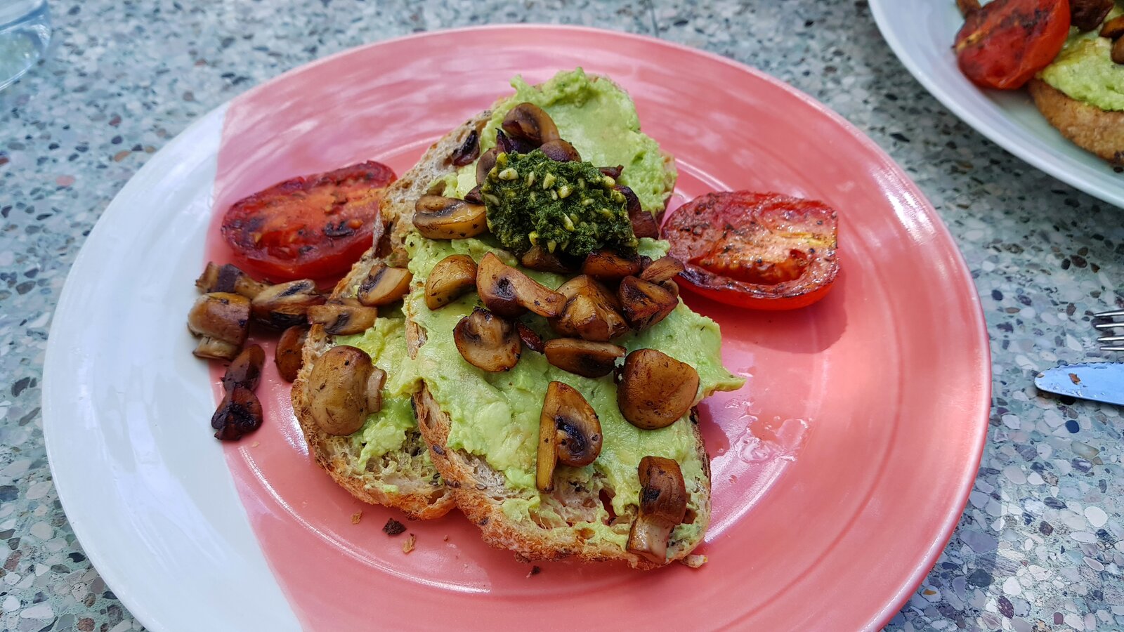 Smashed Avo, fried mushrooms, fried tomatoes with a vegan pesto on toasted sourdough