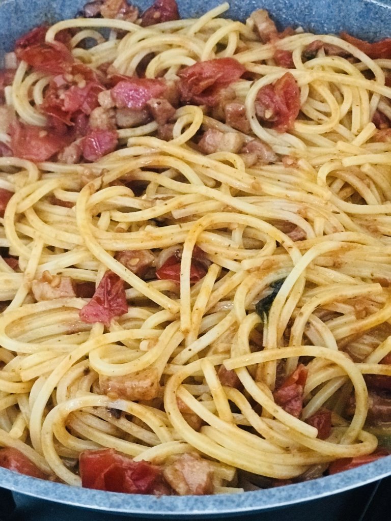 Spaghetti with cherry tomatoes, black garlic, guanciale, pecorino