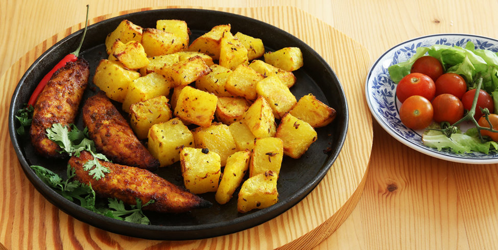 Spicy baked chicken with masala potatoes.