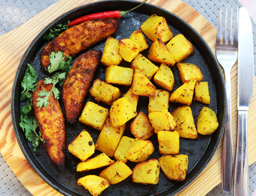 Spicy baked chicken with masala potatoes.