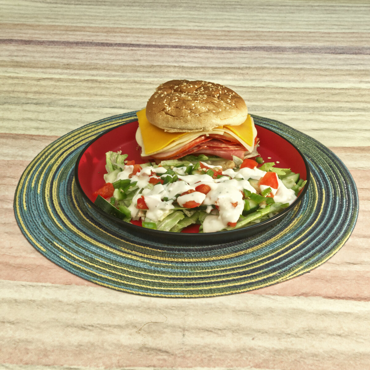Stacked Cold Cuts and Cheese Sandwich with a Layered Salad