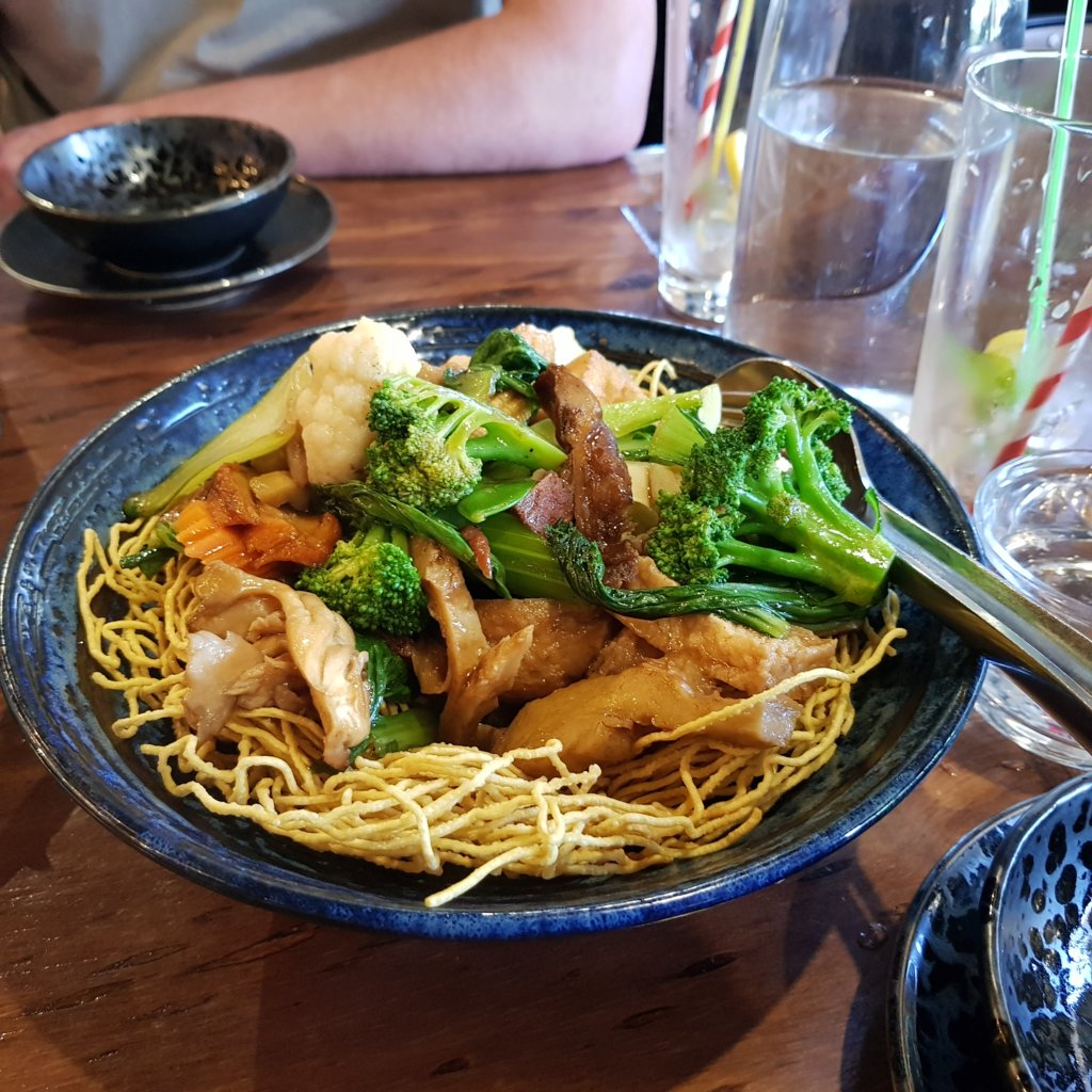 Stir fried combination soy meat with tofu and vegetable and crispy yellow noodles