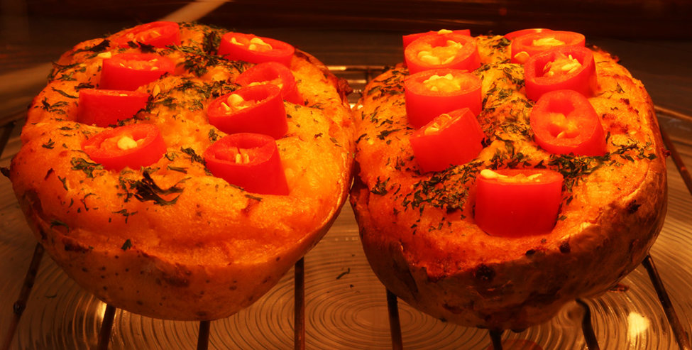 Stuffed jacket potatoes with fresh cayenne chillis.