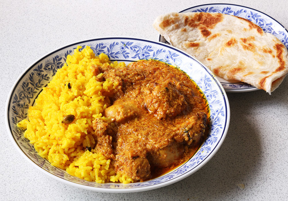 Tikka masala with aromatic rice and a roti.