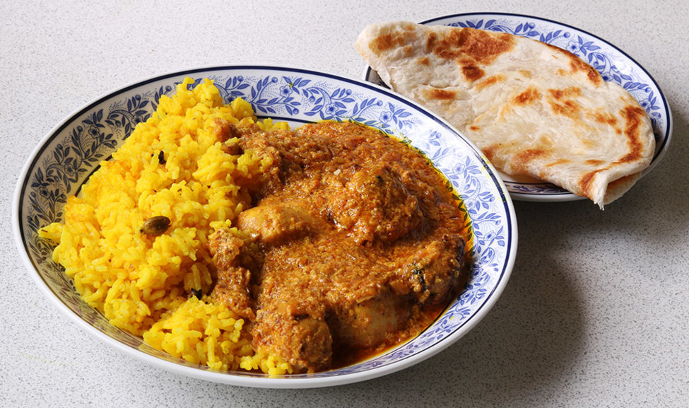 Tikka masala with aromatic rice and a roti.