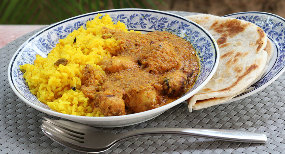 Tikka masala with aromatic rice and a roti.