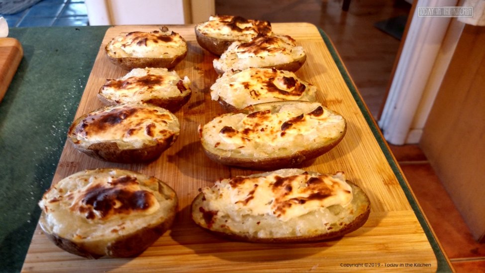 Twice baked potatoes with melted white cheddar cheese