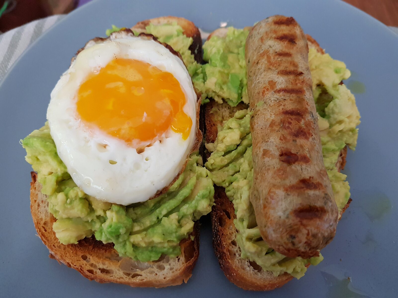 Vegan Chicken 'sausage' & fried egg on smashed Avo on sourdough toast