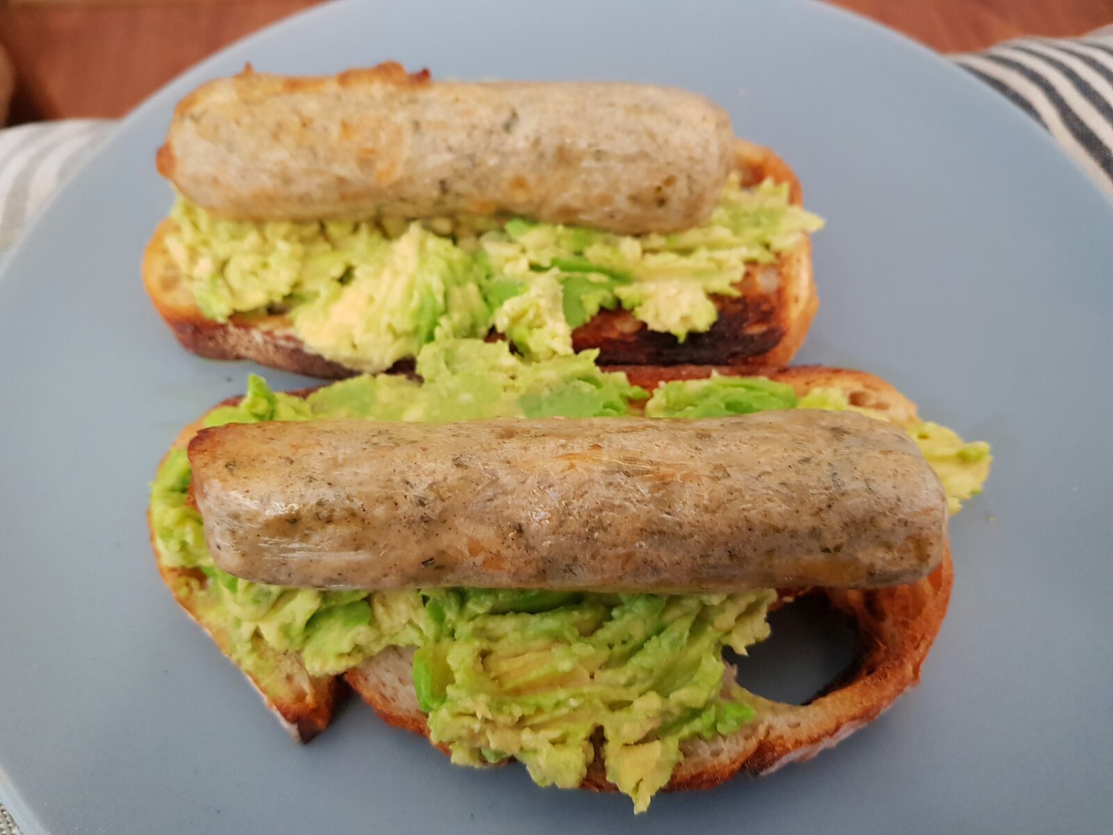 Vegan Chicken 'sausage' on smashed Avo on sourdough toast