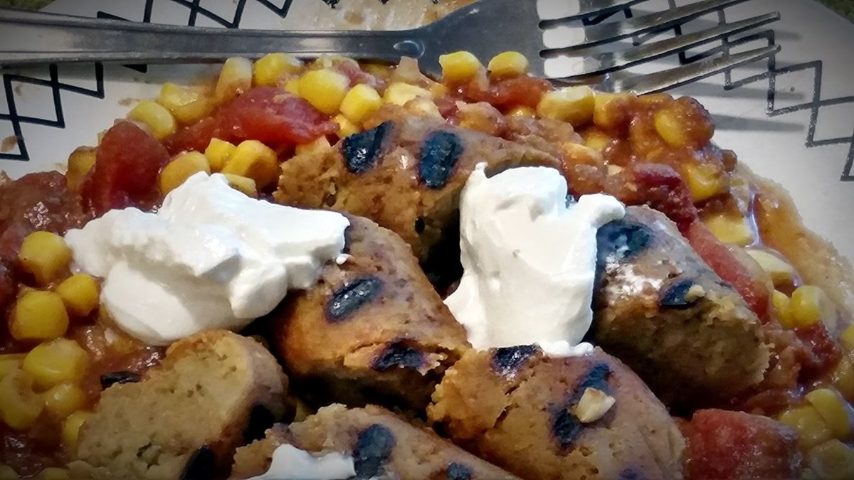 vegan-grilled-sausage-closeup-on-plate-sour-cream.jpg