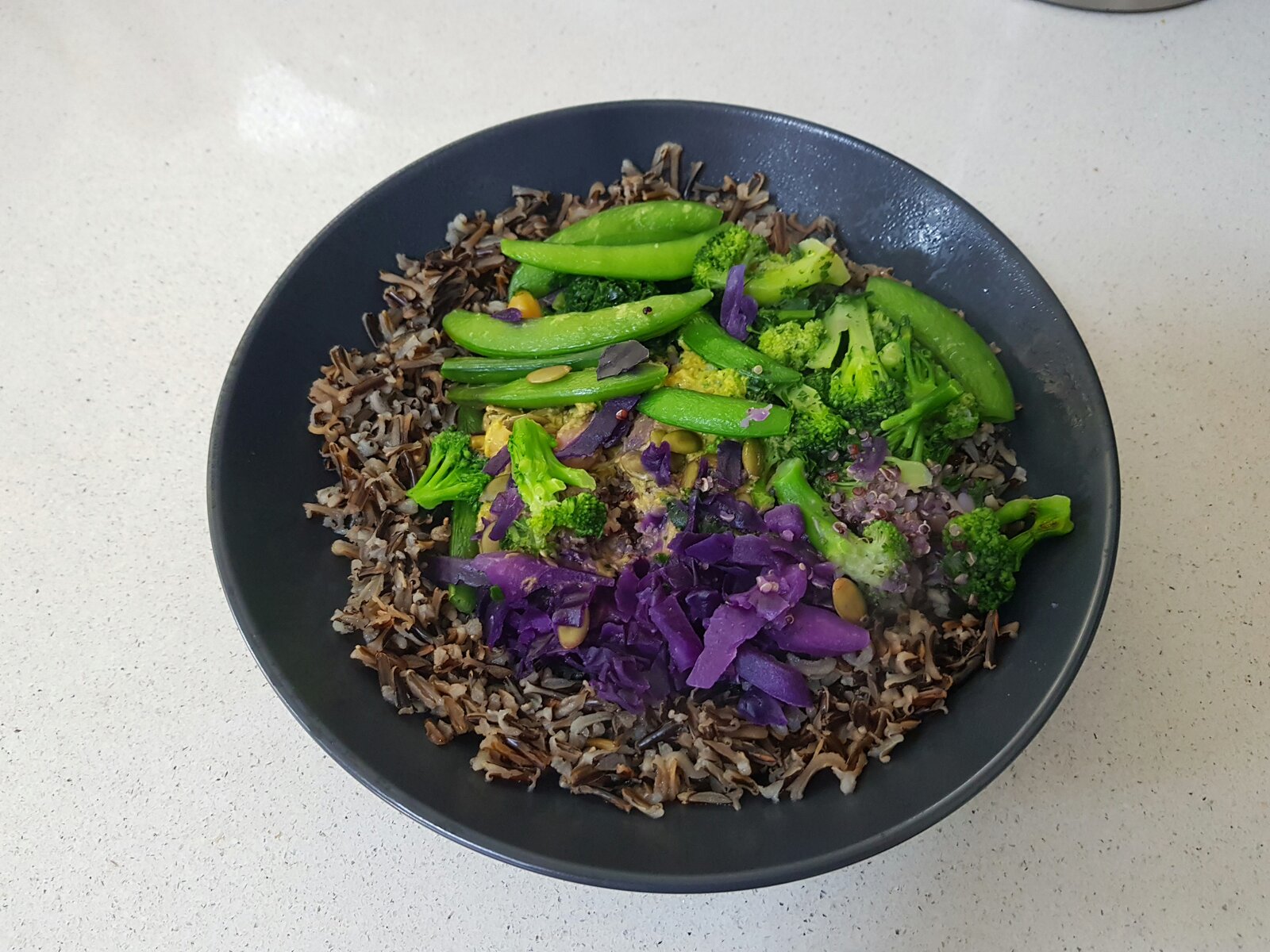 Vegan meal in a bowl with additional wild rice