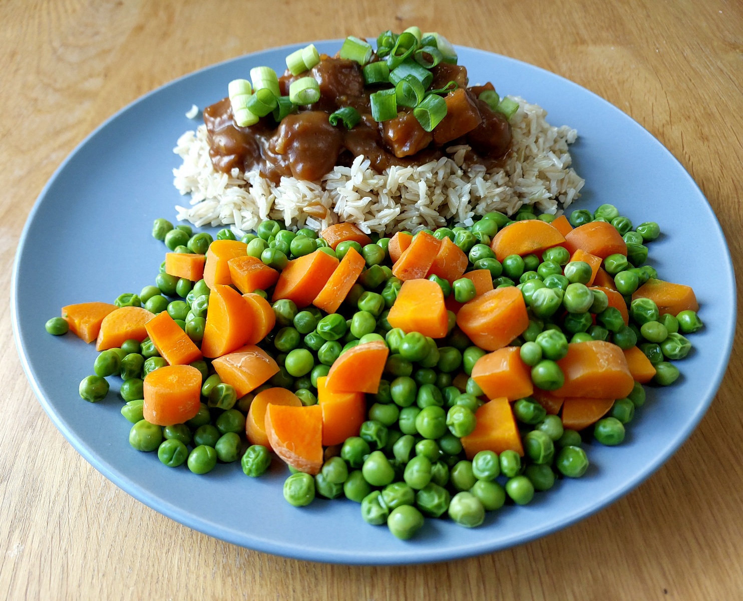 Vegan Orange Glazed Tofu served with brown basmati rice, peas and carrots