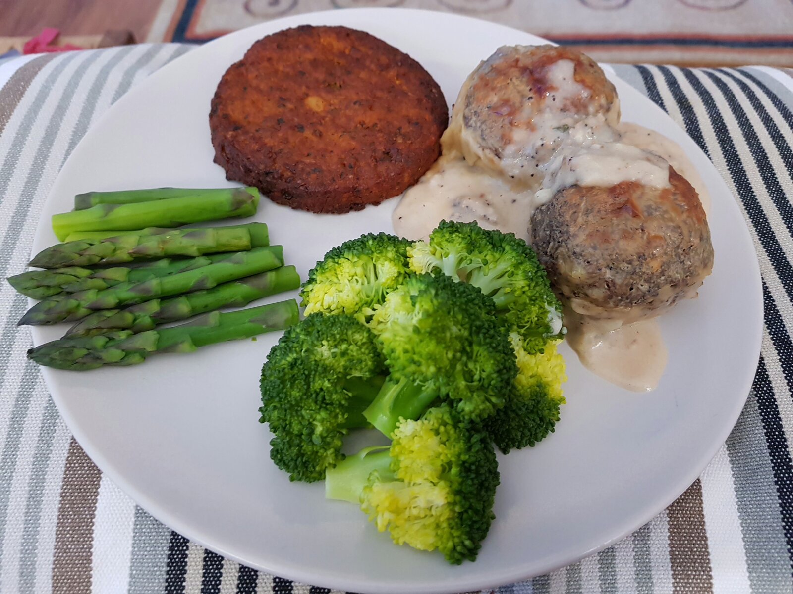 Walnut Dumplings with Bechamel sauce, veggie burger, broccoli and asparagus